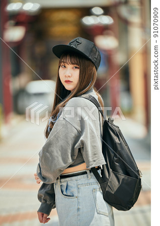 Gen Z women standing looking at the camera 91070909