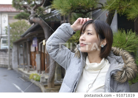 Portrait of a young and beautiful woman posing in the streets of Sawara 91071819