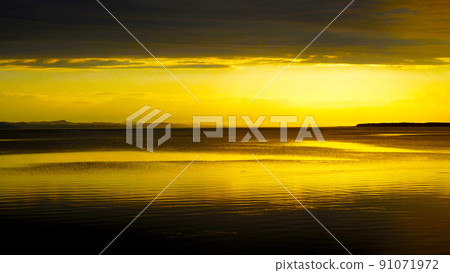 Lake Saroma shining orange at dusk 91071972