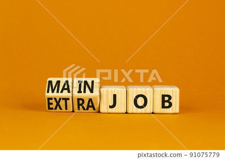 Extra or main job symbol. Turned wooden cubes and changed concept words Extra job to Main job. Beautiful orange table orange background, copy space. Business extra or main job concept. 91075779