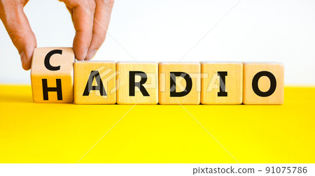 Cardio or hardio symbol. Businessman turns wooden cubes and changes concept words hardio to cardio. Beautiful white background. Sport, healthy lifestyle and cardio or hardio concept. Copy space. Cardio or hardio symbol. Businessman turns wooden cubes and changes concept words hardio to cardio. Beautiful white background. Sport, healthy lifestyle and cardio or hardio concept. Copy space. 91075786