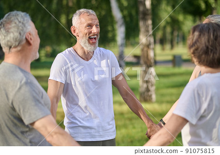 Group of people having a good time in the park on a sunny day 91075815