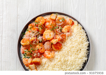 shrimps and scallops with coconut sauce and rice 91075938