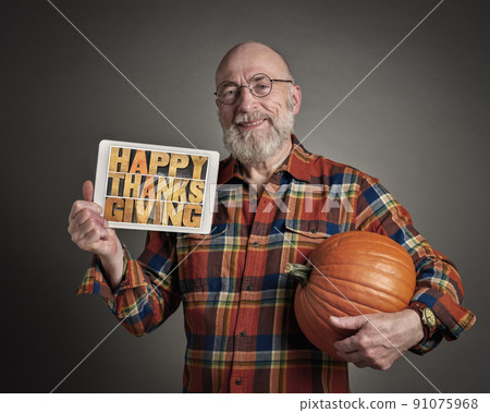 Happy Thanksgiving - a senior man with pumpkin Happy Thanksgiving - a senior man with pumpkin 91075968