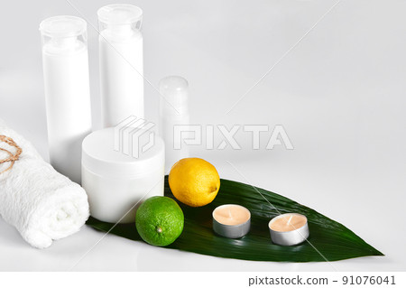 White cosmetic products and green leaf on white background. Natural beauty products for branding mock-up concept. White cosmetic products and green leaf on white background. Natural beauty products for branding mock-up concept. 91076041