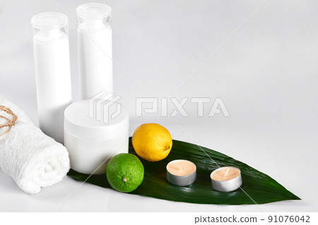 White cosmetic products and green leaf on white background. Natural beauty products for branding mock-up concept. White cosmetic products and green leaf on white background. Natural beauty products for branding mock-up concept. 91076042