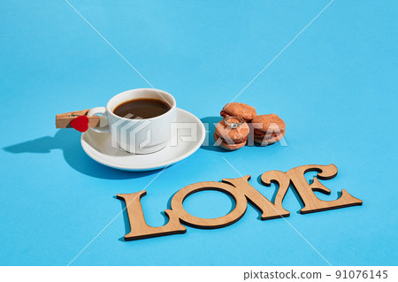 Tasty sweet macarons and coffee cup. Macaroons on blue backgroun 91076145