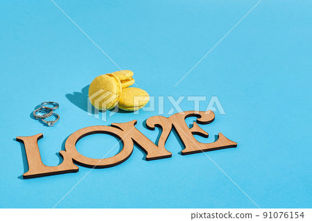 Macaroons on a blue background with the words I love spelt out i Macaroons on a blue background with the words I love spelt out i 91076154