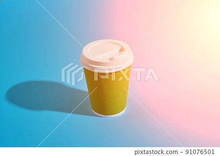 Hot coffee in green paper cup with white lid on blue background 91076501