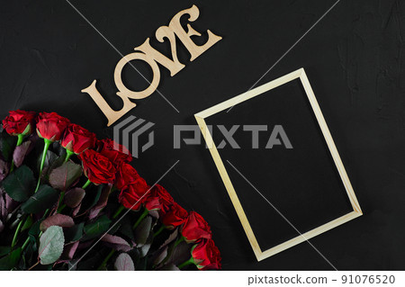 Red roses flowers with wooden word LOVE on black background with 91076520