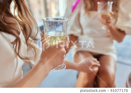 Celebration. People holding glasses of white wine making a toast. 91077178
