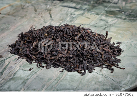 Pu-erh fermented Chinese tea in a roll. Pu-erh fermented Chinese tea in a roll. 91077502