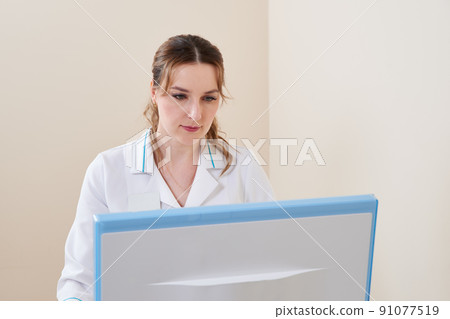 Portrait of a Young professional female doctor in clinic. Close-up of a medicine stuff at hospital with computer 91077519
