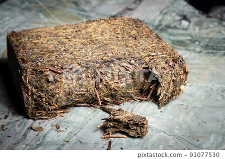 Pu-erh fermented Chinese tea in a roll. Pu-erh fermented Chinese tea in a roll. 91077530