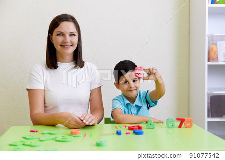 Children practice correct pronunciation with speech therapist Children practice correct pronunciation with speech therapist 91077542
