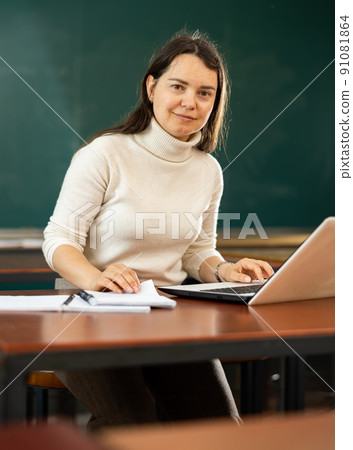 Portrait of female teacher using laptop 91081864