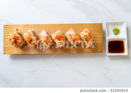 grilled salmon sushi roll with sauce 91085934
