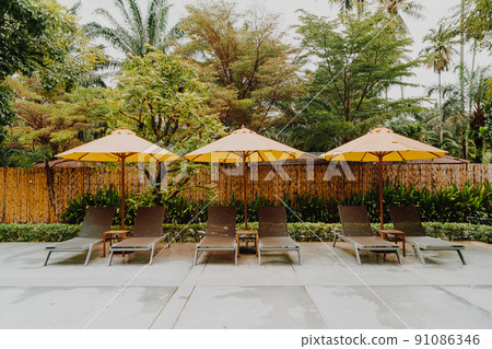 umbrella and pool bed around swimming pool umbrella and pool bed around swimming pool 91086346
