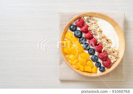 homemade yogurt bowl with raspberry, blueberry, mango and granola 91088768