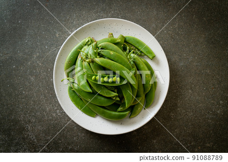 fresh sweet green peas on plate fresh sweet green peas on plate 91088789