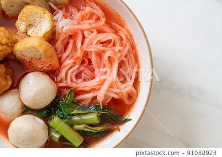 small flat rice noodles with fish balls and shrimp balls in pink soup, Yen Ta Four or Yen Ta Fo 91088923