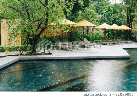 umbrella and pool bed around swimming pool umbrella and pool bed around swimming pool 91089095