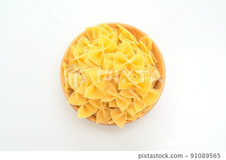 Dry uncooked farfalle pasta on white background Dry uncooked farfalle pasta on white background 91089565