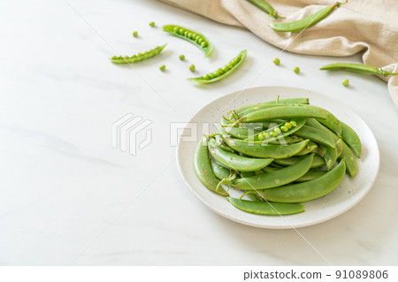 fresh sweet green peas on plate fresh sweet green peas on plate 91089806