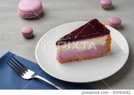 Piece of blueberry cheesecake on a white plate 91091682