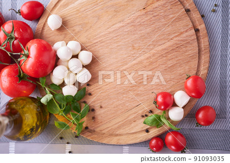 Ingredients for Caprese salad - Mini mozzarella cheese in glass bowl, tomato and basil Ingredients for Caprese salad - Mini mozzarella cheese in glass bowl, tomato and basil 91093035