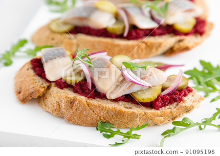 Sandwiches, toasts with salted herring and beetroot pate Sandwiches, toasts with salted herring and beetroot pate 91095198