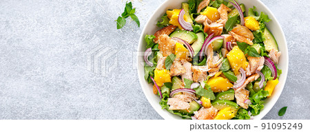 Grilled salmon and mango salad with avocado and fresh green lettuce. Banner 91095249