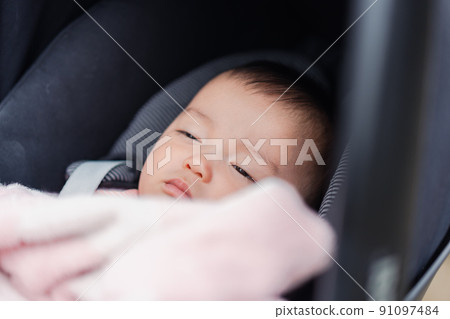 Baby sleeping comfortably in a stroller 91097484