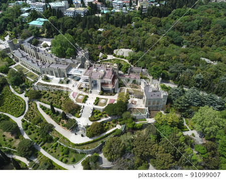 Alupka, Crimea. Aerial view on Vorontsov Palace. 19th century Gothic mansion with well-preserved halls and picturesque park. The palace was built from 1828 to 1848. Travel point of interest Alupka, Crimea. Aerial view on Vorontsov Palace. 19th century Gothic mansion with well-preserved halls and picturesque park. The palace was built from 1828 to 1848. Travel point of interest 91099007