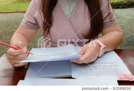 woman working on paperwork on table 91099830