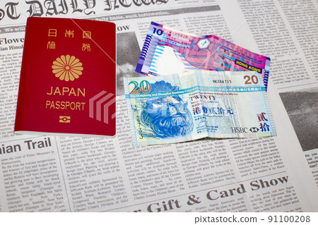 Hong Kong dollar banknotes and Japanese passports placed on English newspapers Hong Kong dollar banknotes and Japanese passports placed on English newspapers 91100208