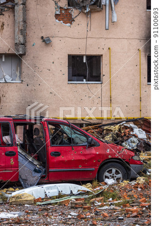 Irpin, Kyev region Ukraine - 09.04.2022: Shot cars. On the streets of Irpin. Cities of Ukraine after the Russian occupation. Irpin, Bucha, Hostomel. Destroyed and burnt houses in the background. 91100693