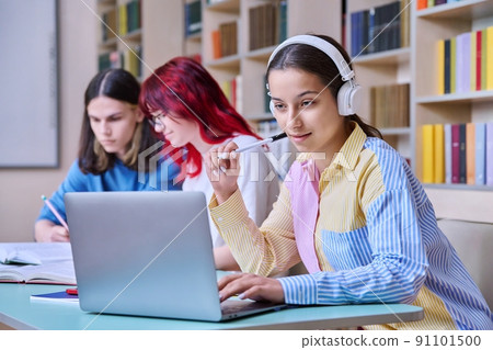 Group of teenage students study in school library Group of teenage students study in school library 91101500