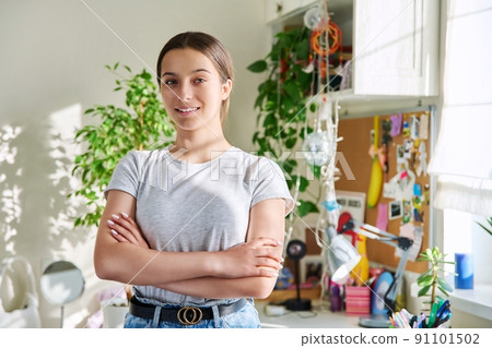 Portrait of smiling teenager girl 14, 15 years old looking at camera, at home in room Portrait of smiling teenager girl 14, 15 years old looking at camera, at home in room 91101502
