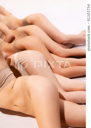 Image of slender, smooth female buttocks in beige underwear isolated over grey studio background. Anti-cellulite treatment. Side view 91101734