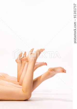 Image of slender female legs isolated over grey studio background. Smooth skin. Depilation, epilation body care 91101737