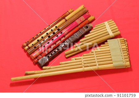 Latin American folk instruments, Sikuri and Quena, red background Latin American folk instruments, Sikuri and Quena, red background 91101759