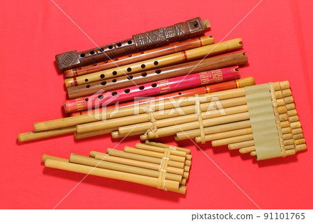 Latin American folk instrument, quena and seek, red background Latin American folk instrument, quena and seek, red background 91101765