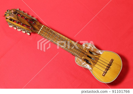 Latin American folk instrument, charango, red background 91101766