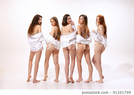 Rear view portrait of five slim women posing in beige cotton underwear and shirt isolated over white studio background. Fit buttocks 91101799