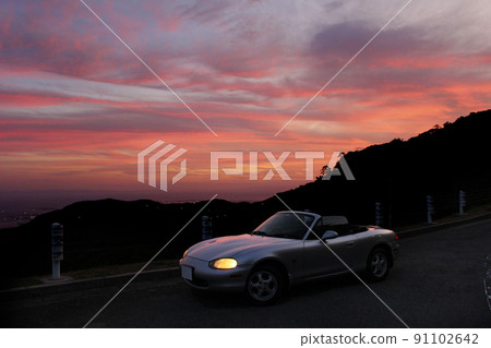 Sunset, mountains and sports car Sunset, mountains and sports car 91102642