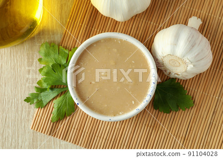 Concept of tasty food with tahini sauce on light wooden background 91104028