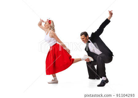 Astonished young man and woman in retro style outfits dancing lindy hop isolated on white background. Art, music, fashion, style concept Astonished young man and woman in retro style outfits dancing lindy hop isolated on white background. Art, music, fashion, style concept 91104293