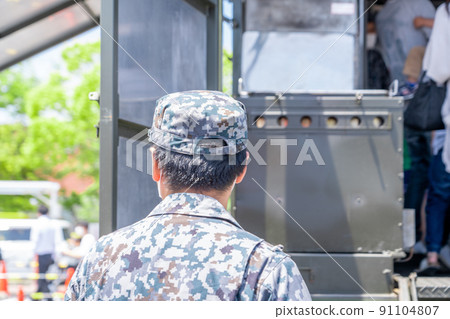 Image of the back view of SDF personnel watching over the people 91104807