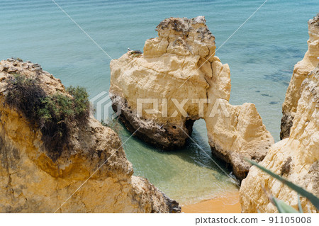 The rocky cliffs of Vale do Olival beach in Armacao de Pera, Portugal 91105008